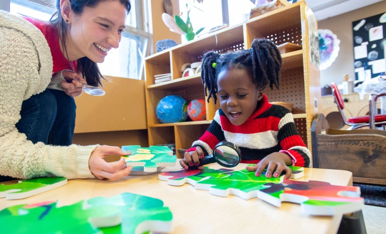 child playing with student teacher at SIU