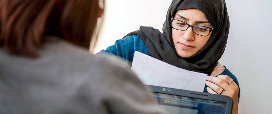 SIU-C student reading a paper